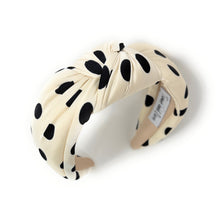 Load image into Gallery viewer, Cream-colored headband with black polka dots, featuring a twisted knot design. The brand tag reads "Twine and Love," adding a touch of elegance.