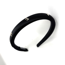 Load image into Gallery viewer, Black headband with small silver bows decorative charms on a white background