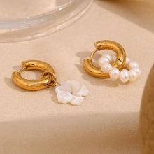 Load image into Gallery viewer, 18k Gold plated hoop earrings with pearl accents and a floral charm on a beige surface.