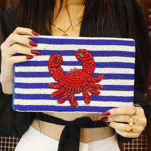 Load image into Gallery viewer, Woman wearing pink ribbon jeweled earrings with a white sleeveless top with a yellow background