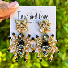 Load image into Gallery viewer, Halloween beaded Earrings, spider Earrings, halloween Earrings, spider Halloween Earrings, earrings for halloween, spider beaded earrings, spooky beaded earrings, spider jeweled earrings, Unique earrings, statement earrings, Halloween jewelry, spider earrings, unique jeweled earrings, spooky earrings, costume jewelry, Holiday earrings, custom earrings, custom designs, dangling earrings, lightweight earrings, halloween accessories, halloween vibes, spooky vibes, handmade gifts, handmade gifts, custom gifts
