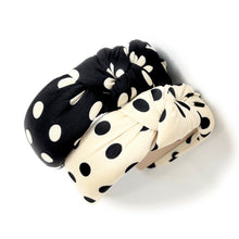 Load image into Gallery viewer, Two polka dot headbands, one black and white, one white and black, on a white background.