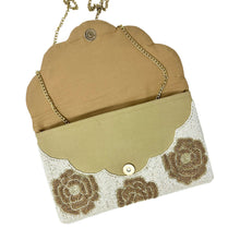Load image into Gallery viewer, Elegant beige clutch adorned with intricate gold beaded floral patterns. The symmetrical design exudes a vintage, sophisticated charm.
