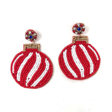 Load image into Gallery viewer, Two festive beaded earrings featuring red baubles with white swirl patterns and gold tops. The tops have small colored beads, enhancing their vibrant look.