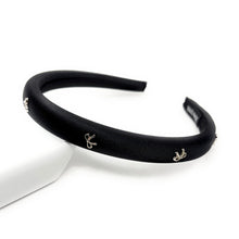 Load image into Gallery viewer, Black headband with small silver bow decorative charms on a white background