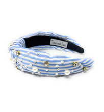 Load image into Gallery viewer, A stylish headband with blue and white stripes, adorned with pearls and sparkling gems. It has a knotted design, offering a chic and elegant look.