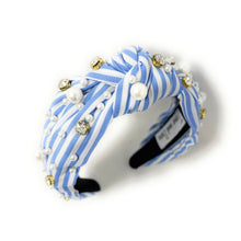 Load image into Gallery viewer, A stylish headband with blue and white stripes, adorned with pearls and sparkling gems. It has a knotted design, offering a chic and elegant look.