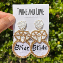Load image into Gallery viewer, Bride earrings, bride champagne bottle earrings, bridal earrings, bridal shower gift, bachelorette earrings, bridal gift, bride to be gift, bachelorette gift, bridal shower, bride statement earrings, bridal gift, bachelorette party, earrings for bride, best friend gift, bachelorette gift, white bride earrings, birthday gift for bride, party treats for bride. bride to be gift, gifts for bridal shower, gift for bride, gift for bachelorette, gift for a future bride, future bride gift, bridesmaids gifts