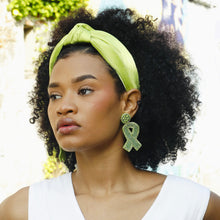 Load image into Gallery viewer, Close-up of a woman styling a lime green knotted headband, perfect for spring, summer, and everyday wear.