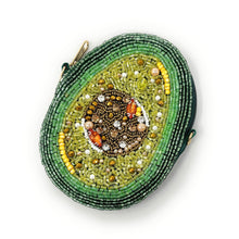Load image into Gallery viewer, A beaded pouch shaped like an avocado half, with green and brown beads depicting the fruit and seed, creating a vibrant, textured design.