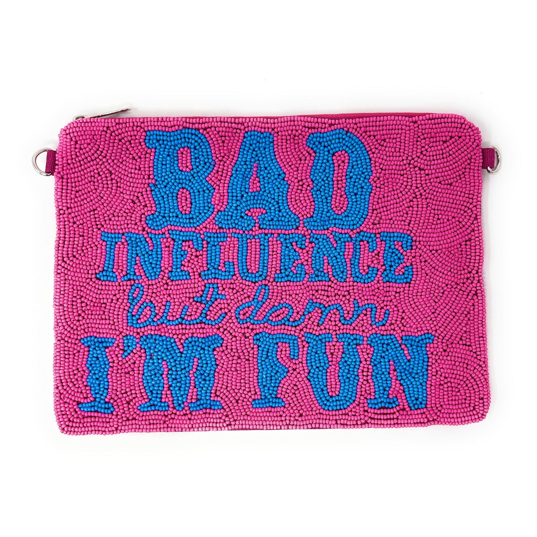 A pink clutch bag with blue beaded text reading 