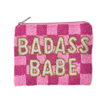 Load image into Gallery viewer, A pink and magenta checkered beaded pouch with the words 'BADASS BABE' in large gold and white beaded letters, featuring a silver zipper closure.