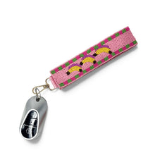 Load image into Gallery viewer, Hand beaded banana wristlet keychain featuring three yellow bananas on a pink beaded strap with green and purple accents. Includes a gold-tone lobster clasp and comfortable wrist loop, perfect for holding keys, key fobs, or ID badges.