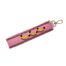 Load image into Gallery viewer, Hand beaded banana wristlet keychain featuring three yellow bananas on a pink beaded strap with green and purple accents. Includes a gold-tone lobster clasp and comfortable wrist loop, perfect for holding keys, key fobs, or ID badges.