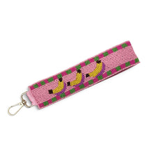 Load image into Gallery viewer, Hand beaded banana wristlet keychain featuring three yellow bananas on a pink beaded strap with green and purple accents. Includes a gold-tone lobster clasp and comfortable wrist loop, perfect for holding keys, key fobs, or ID badges.