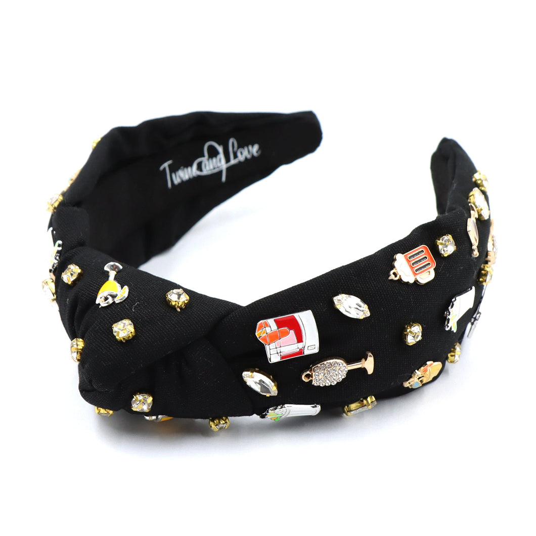 Black headband adorned with small, colorful different drink charms and rhinestones, creating a playful and chic vibe. Features the 
