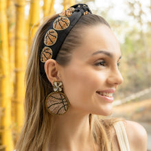 Load image into Gallery viewer, Woman wearing a black basketball headband with matching basketball earrings outdoors.