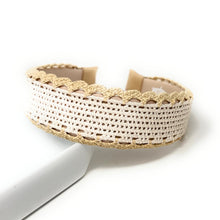 Load image into Gallery viewer, A wide white woven mesh cuff bracelet with a textured gold glitter trim and scalloped gold lace edges, displayed on a white surface.