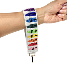 Load image into Gallery viewer, Beaded wristlet keychain strap with crayon design on a wrist against a white background