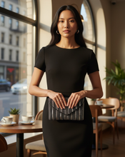 Load image into Gallery viewer, Woman holding a clutch in a cafe setting