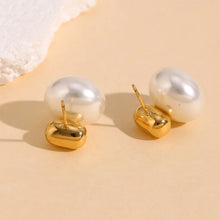 Load image into Gallery viewer, Pearl earrings with 18k gold plated bases on a beige background
