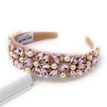 Load image into Gallery viewer, Pink jeweled headband adorned with sparkling pink gemstones and pearls on a soft pink fabric. Elegant, luxurious, and feminine design.