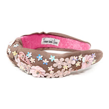 Load image into Gallery viewer, light Brown headband with pink interior, adorned with colorful floral applique and beading. The vibe is playful and feminine, showcasing detailed craftsmanship.
