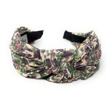 Load image into Gallery viewer, A floral patterned headband with a knot design, featuring shades of green, purple, and pink. It sits against a plain white background, conveying a stylish and feminine tone.