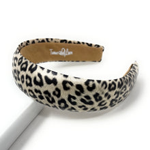 Load image into Gallery viewer, Leopard print headband with a smooth, rounded shape on a white background. The pattern is bold and stylish, conveying a trendy, fashionable vibe.