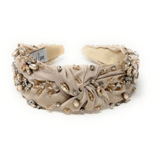 Load image into Gallery viewer, Elegant beige headband adorned with sparkling crystals and gemstones. The luxurious fabric is delicately ruched, creating a sophisticated and glamorous look.