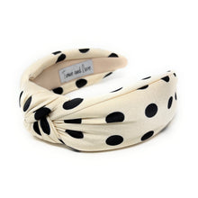 Load image into Gallery viewer, Cream-colored headband with black polka dots, featuring a twisted knot design. The brand tag reads &quot;Twine and Love,&quot; adding a touch of elegance.