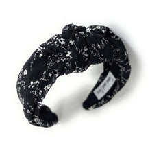 Load image into Gallery viewer, Vintage-inspired black floral twist headband with white print and structured padded style.