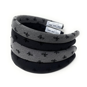 Set of gray and black headbands with a bow pattern on a white background