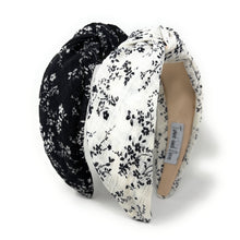 Load image into Gallery viewer, Set of black and white floral knotted headbands with padded twist design on a neutral background.