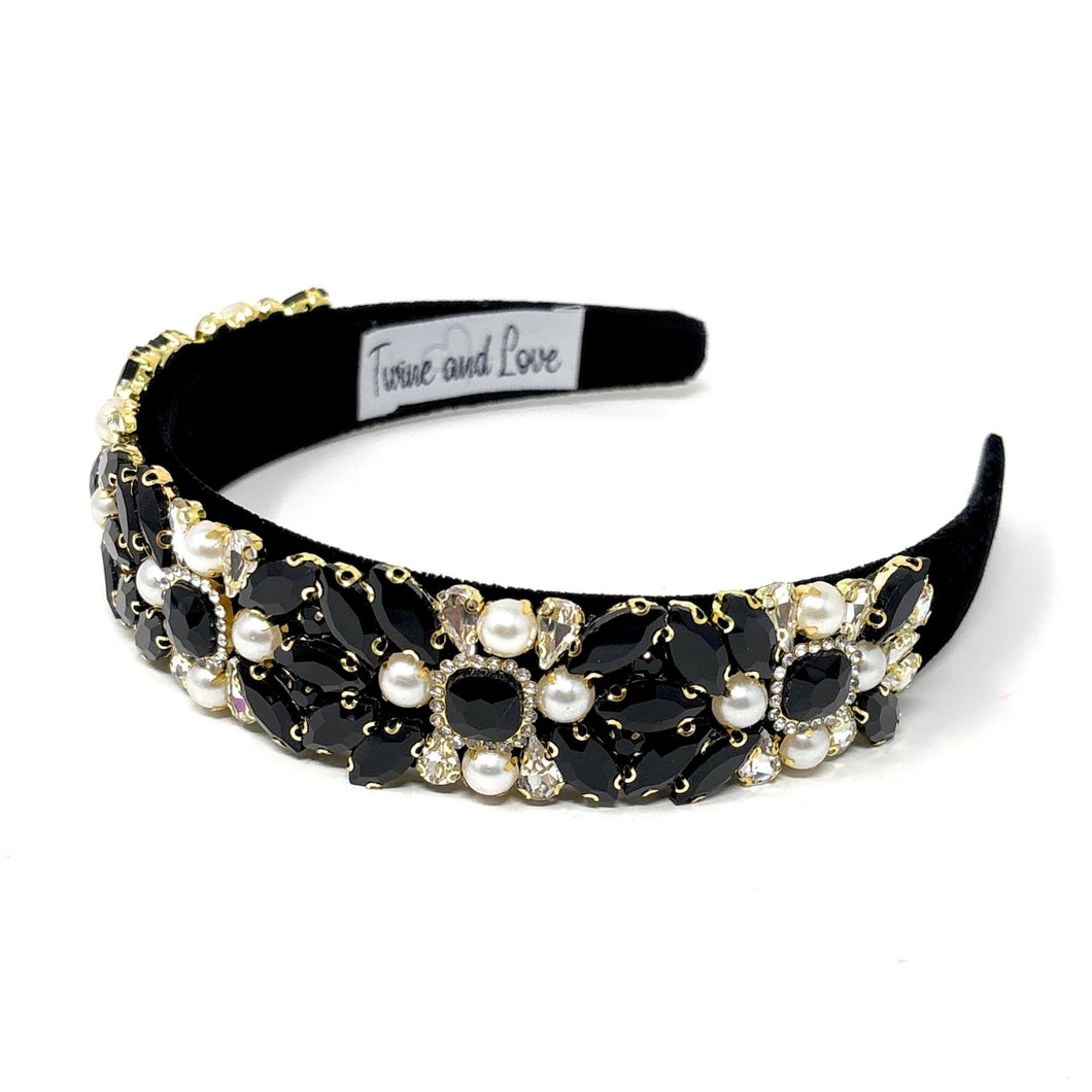 Elegant black headband adorned with clusters of white pearls and black crystals, creating a luxurious and sophisticated look.