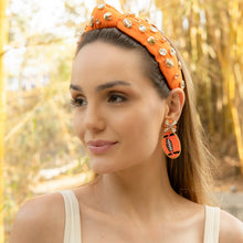 Load image into Gallery viewer, Woman wearing an orange headband and earrings with a blurred natural background