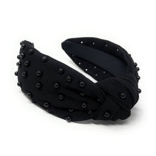 Load image into Gallery viewer, Black fabric headband adorned with small black beads, featuring a knotted design in the center. 