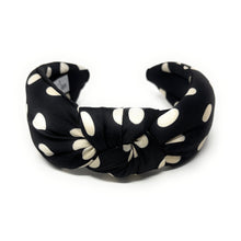 Load image into Gallery viewer, Black headband with cream polka dots, featuring a twisted knot design. A label inside reads &quot;Twine and Love.&quot; The style is stylish and playful.