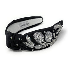 Load image into Gallery viewer, A black headband adorned with intricate silver floral embroidery and shimmering gemstones, conveying elegance and luxury.