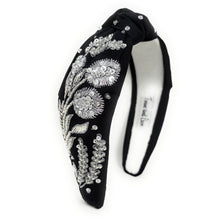 Load image into Gallery viewer, Black headband with floral embellishments on a white background