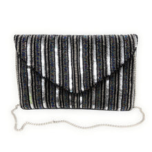 Load image into Gallery viewer, Silver and black sequined clutch with vertical stripes. It features a triangular flap and a silver chain strap, exuding a glamorous, elegant vibe.