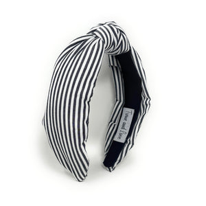 Black and white striped headband on a white background