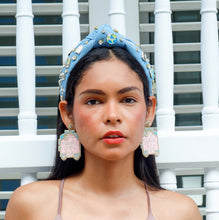 Load image into Gallery viewer, Fashion portrait featuring a light blue jeweled denim headband paired with blush statement earrings.
