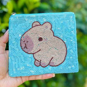 Blue sequin pouch featuring a cute capybara design in beige and brown beads. The playful, whimsical tone is accented by a silver zipper.
