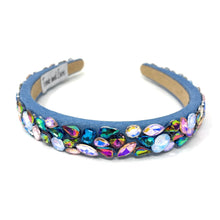 Load image into Gallery viewer, A vibrant, gemstone-encrusted headband with a blue fabric base adorned with multicolored jewels, including blue, purple, and gold, emanating a luxurious and playful vibe.