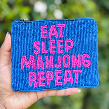 Load image into Gallery viewer, Blue beaded pouch with 'Eat Sleep Mahjong Repeat' text held in front of a blurred green background