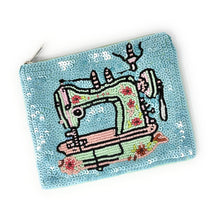 Load image into Gallery viewer, Stylish blue clutch adorned with a sewing machine illustration and sequins.