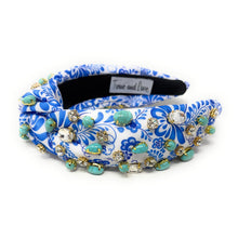 Load image into Gallery viewer, A blue and white floral-patterned headband adorned with turquoise stones and sparkling gems. It conveys a vibrant, elegant, and artistic flair.