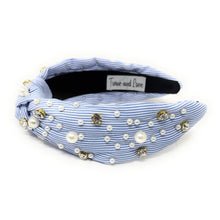 Load image into Gallery viewer, A blue and white striped headband adorned with pearls and gold beads. It features a knot design, creating an elegant and stylish accessory.