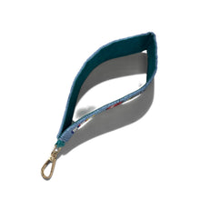 Load image into Gallery viewer, A fabric wristlet pouch with a teal blue interior and a light blue patterned exterior, featuring a gold-tone lobster clasp, shown on a white background with a soft shadow.